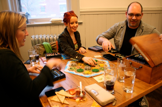 A group playing a 3D version of Settles of Catan